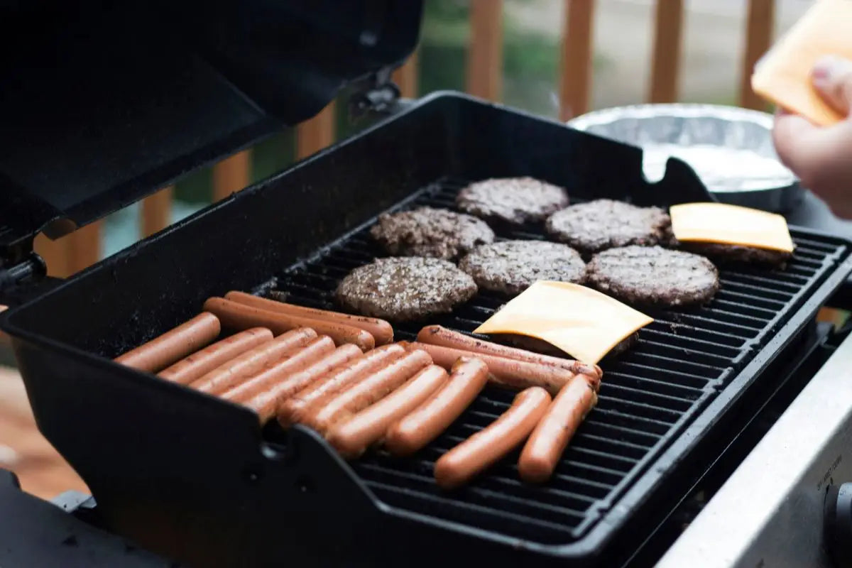 Bbq With Hamburger Patties, Hot Dogs, And Cheese On Grill; Expert Game Meat Grilling Tips.