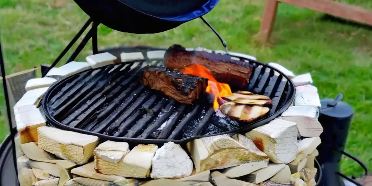 Circular Grill With Meat And Vegetables Cooking Over Flames In a Stone Or Brick Base.