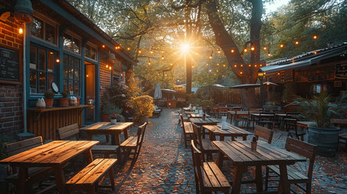 Cozy Outdoor Restaurant Patio With Wooden Tables And String Lights At Sunset.