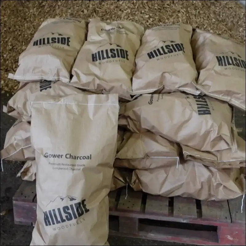 2kg Wholesale Bags Of Restaurant Grade Lump Charcoal Stacked On a Pallet For Bulk Purchase