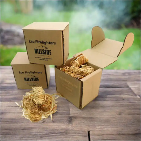 Three Boxes Of Natural Wood Wool Firelighters On a Wooden Table