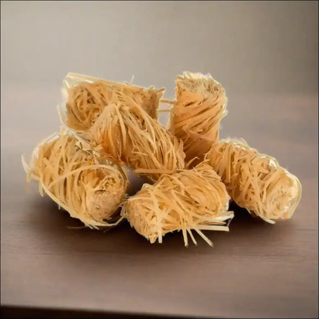 Close Up Of Natural Wood Wool Firelighters Resembling Noodles On a Table